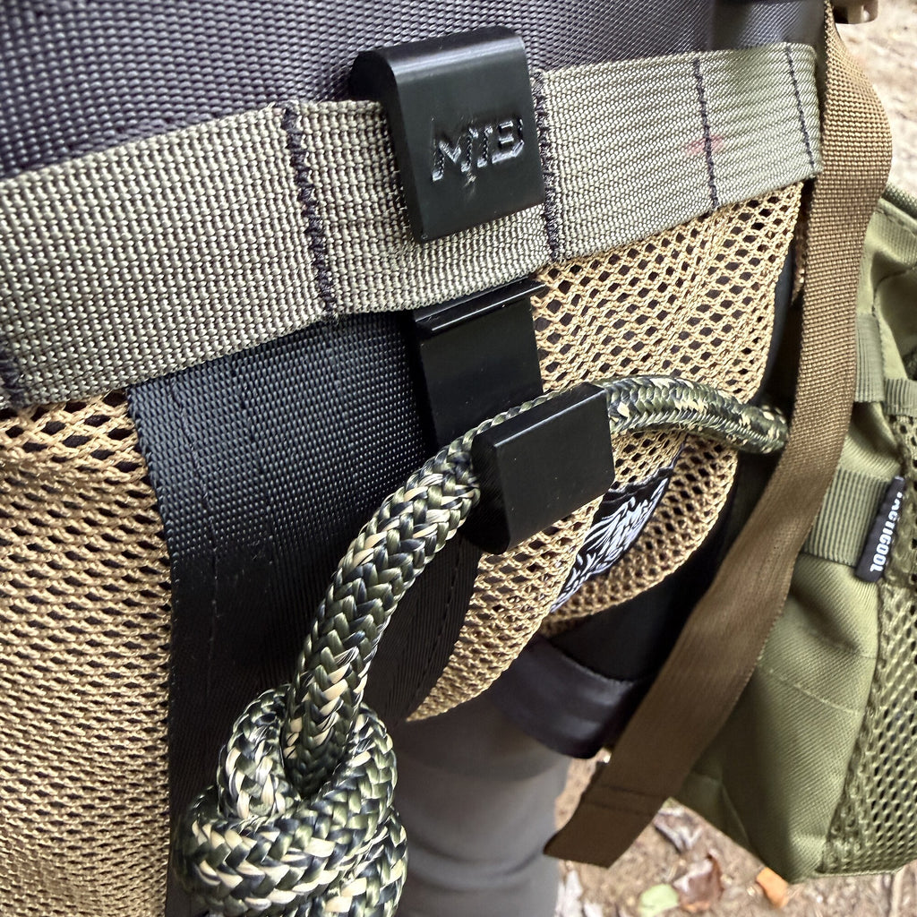 Close detail of the SC2 Bridge Clip mounted to MOLLE webbing