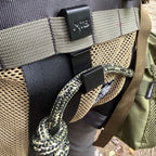 Close detail of the SC2 Bridge Clip mounted to MOLLE webbing