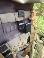 Black SC3 platform hook mounted on MOLLE webbing, close-up view