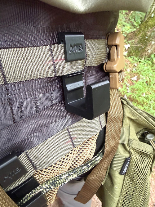 Black SC3 platform hook mounted on MOLLE webbing, close-up view